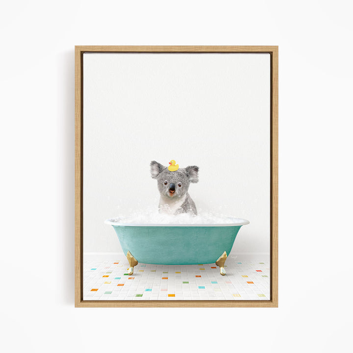 A koala bear sitting in a blue bathtub filled with bubbles, wearing a yellow rubber duck hat.