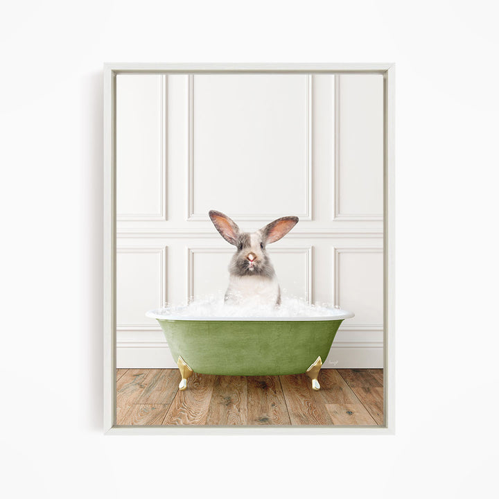 A white rabbit sitting in a green bathtub filled with water, looking directly at the camera.