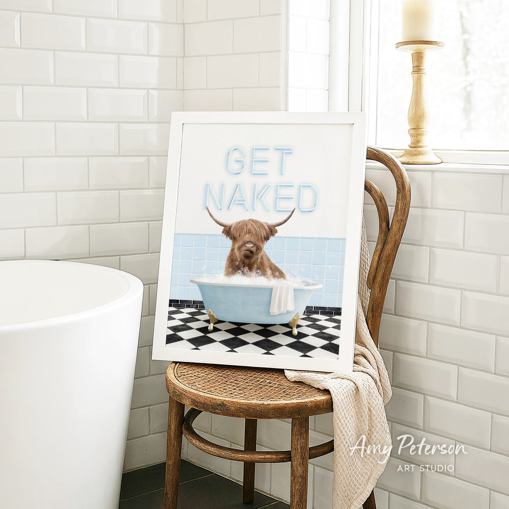 A framed image of a dog sitting in a bathtub, with the text "GET NAKED" displayed on the frame.