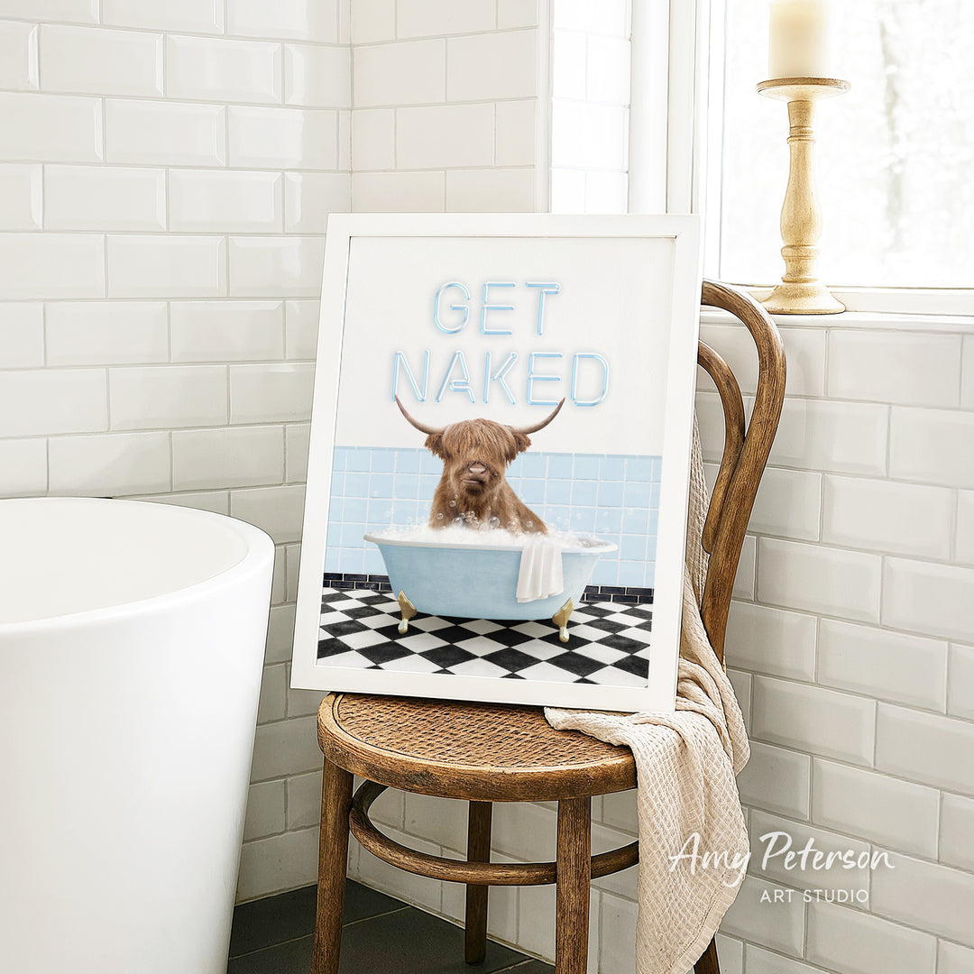 A framed image of a dog sitting in a bathtub, with the text "GET NAKED" displayed on the frame.