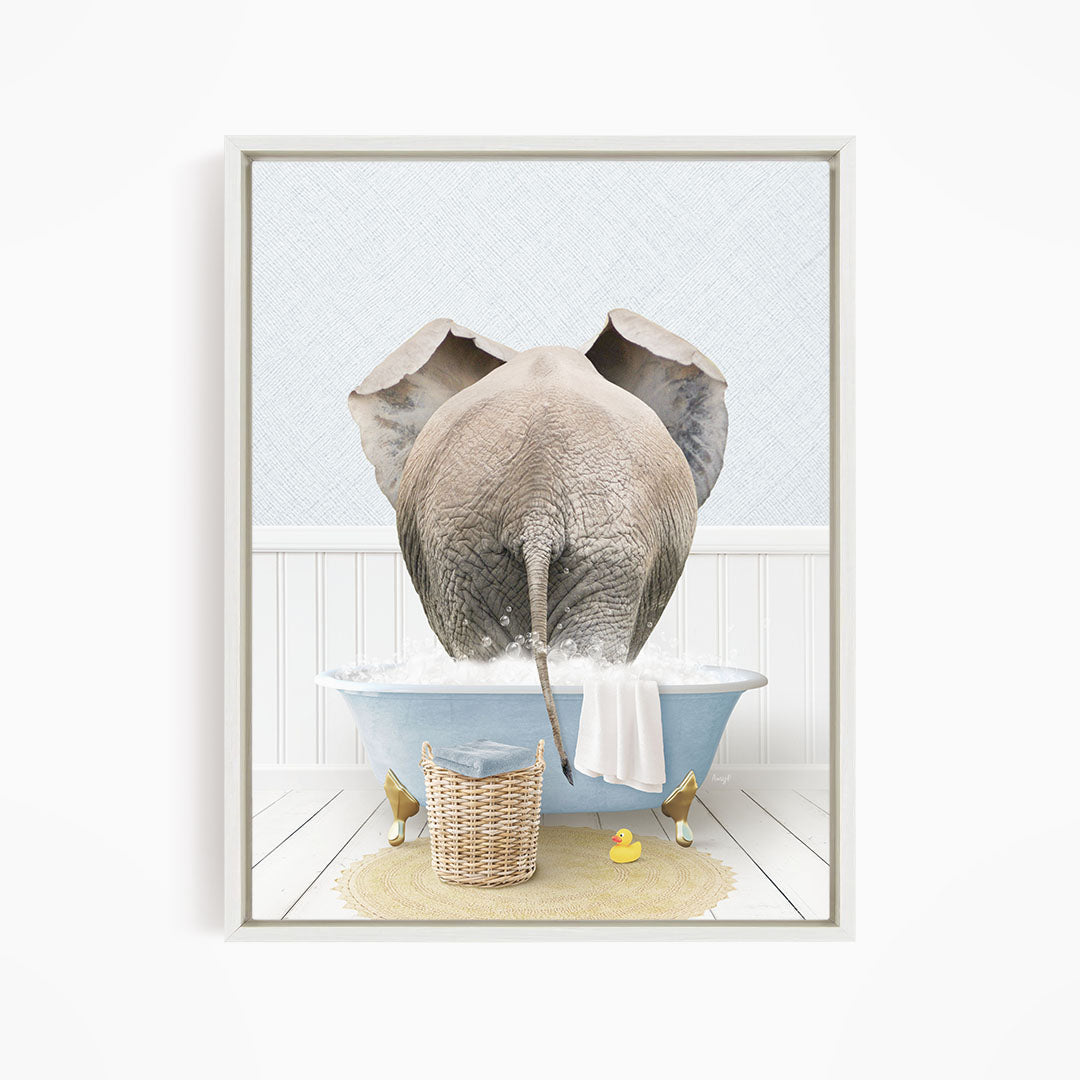 A gray elephant is standing in a blue bathtub filled with water, surrounded by a yellow rubber duck and a basket.