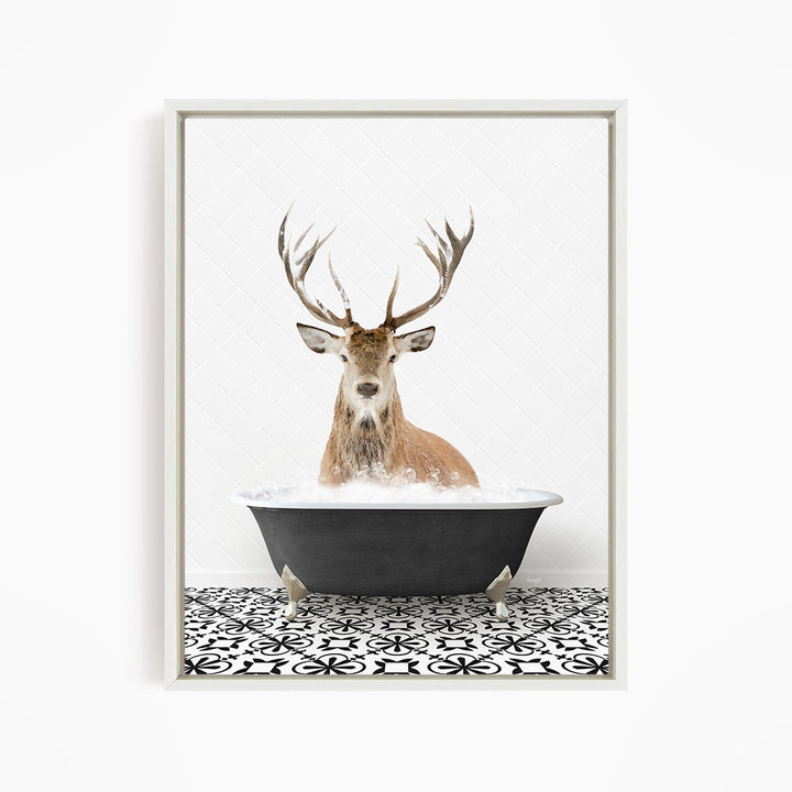 A deer with large antlers is sitting in a bathtub filled with water, creating a whimsical and unexpected scene.