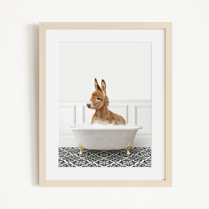 A donkey is sitting in a white bathtub filled with bubbles, creating a playful and whimsical scene.