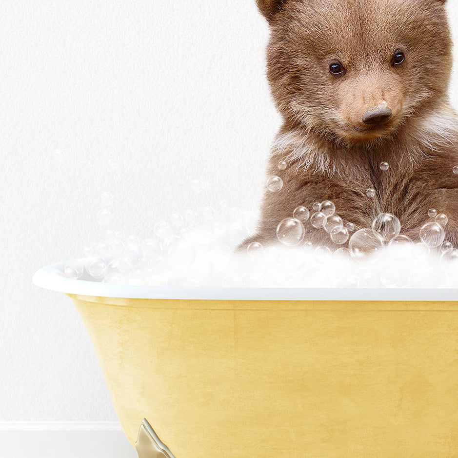 a brown bear sitting in a bath tub filled with bubbles