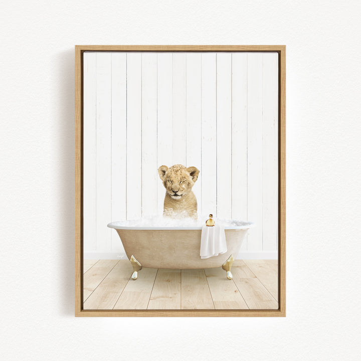A young lion cub sitting in a bathtub filled with water, surrounded by a white wooden wall.