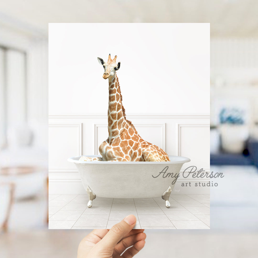 a giraffe sitting in a bathtub with a hand holding it