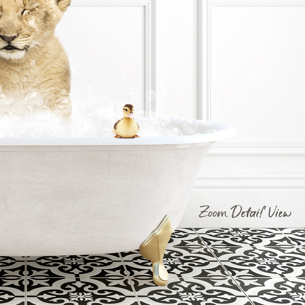 A white clawfoot bathtub filled with bubbles, with a small yellow duck sitting on the edge and a lion resting in the tub.
