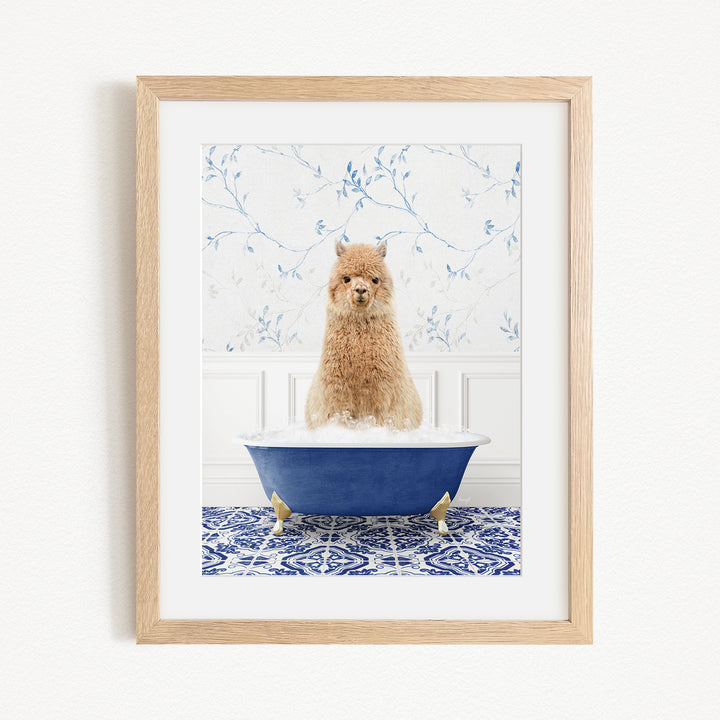 A small brown dog sitting in a blue bathtub filled with bubbles, with a blue and white floral patterned wall behind it.