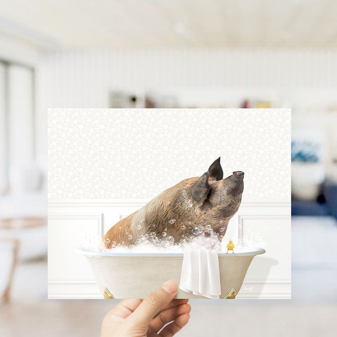 A hand holds up a collage of images depicting a pig bathing in a tub, with a yellow duck nearby.