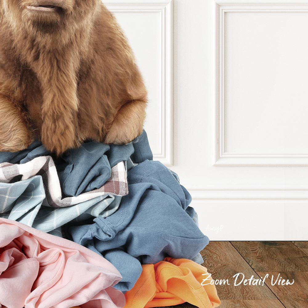A close-up of a dog's head peeking over a pile of clothes, with a white wall and wooden floor in the background.