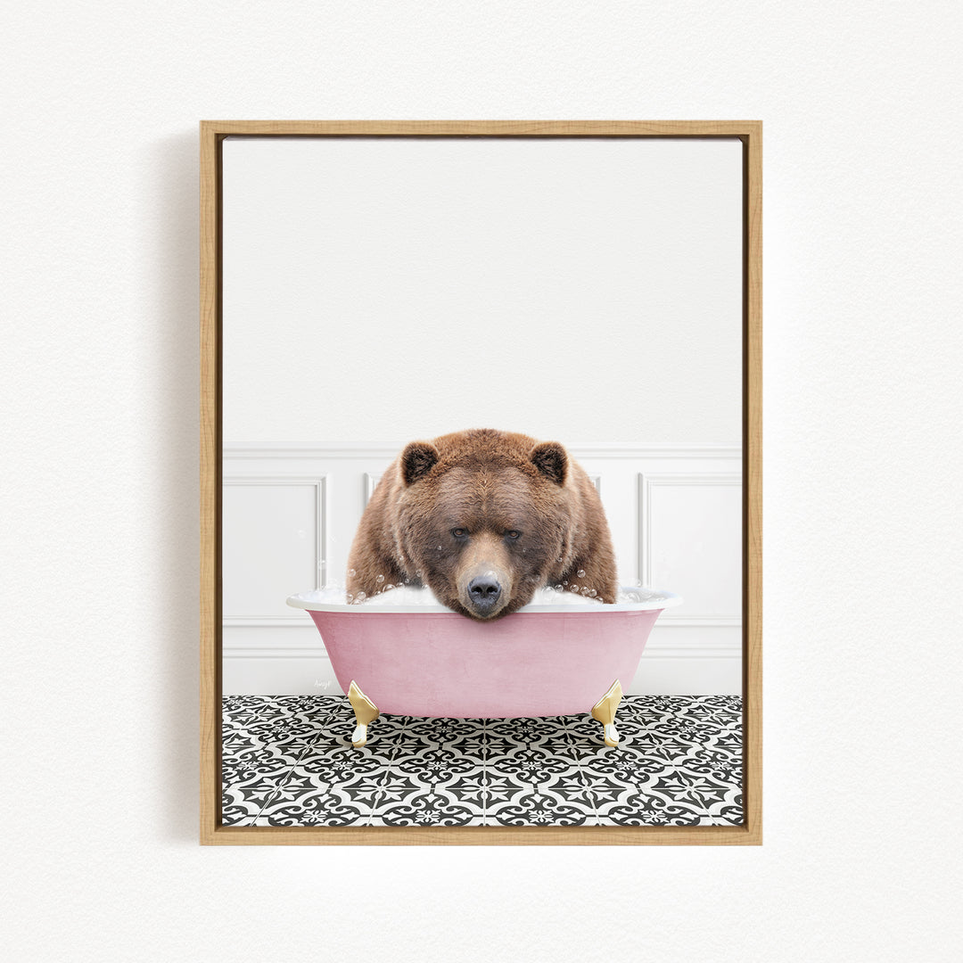 A brown bear is sitting in a pink bathtub, appearing to be enjoying a bath.