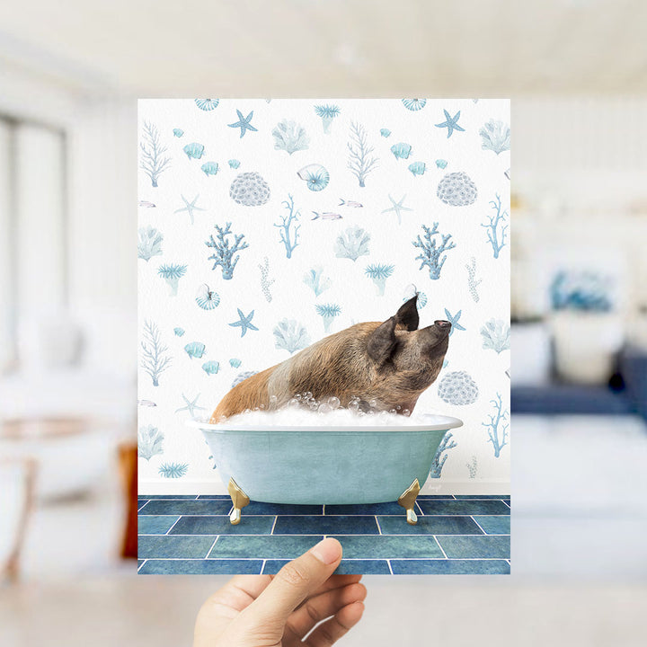 A hand holds up a collage of images featuring a pig sitting in a bathtub filled with bubbles, surrounded by a blue and white ocean-themed background.