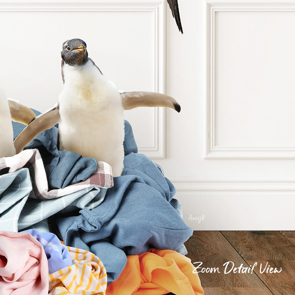 A penguin standing on a pile of clothes, with a white wall and wooden floor in the background.