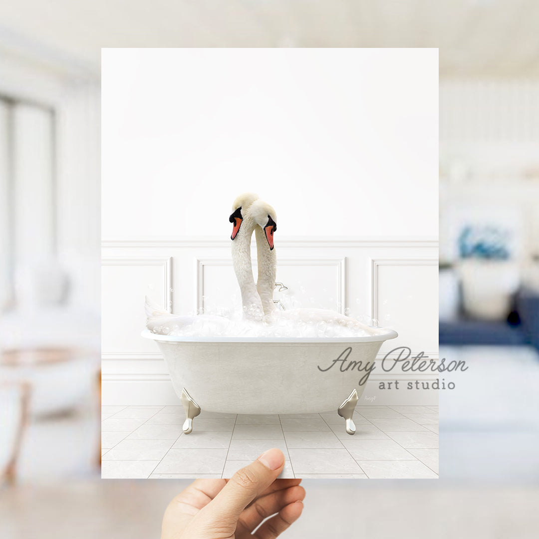 a person holding a card with a picture of two swans in a bathtub