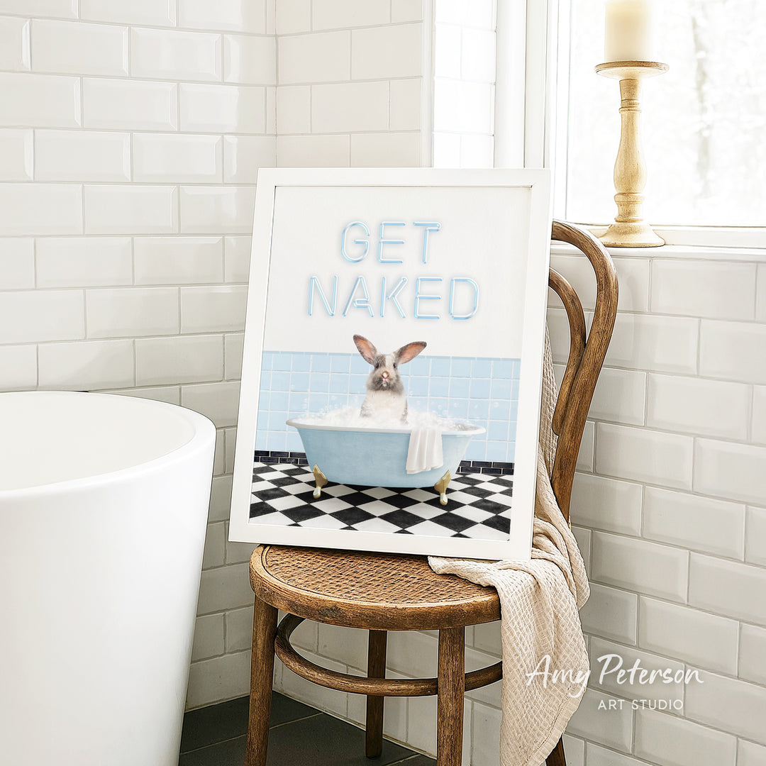 A framed image of a pig sitting in a bathtub, with the text "GET NAKED" displayed on the frame.