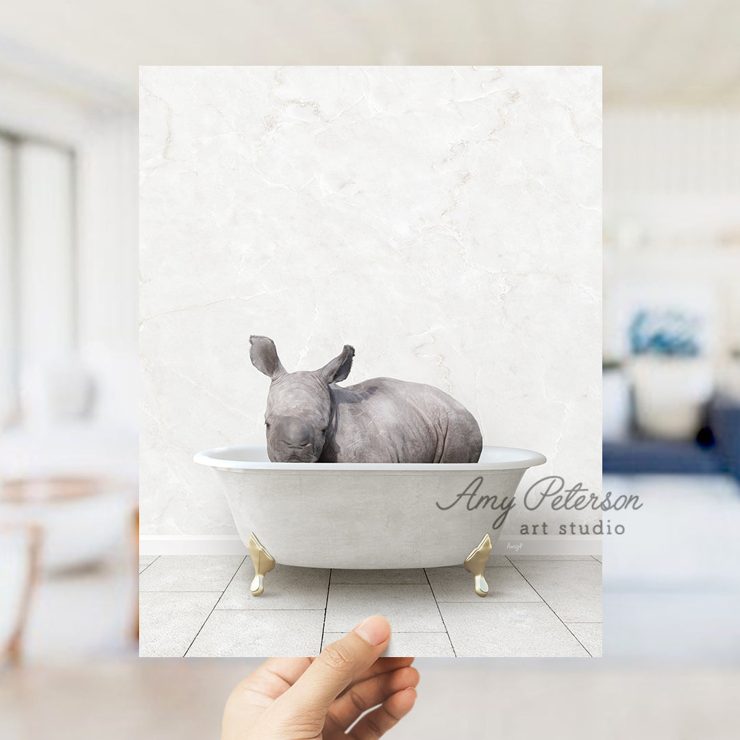 a hand holding up a card with a picture of a rhino in a bathtub