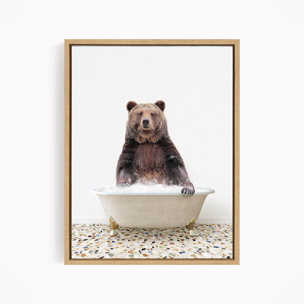 A brown bear sitting in a white bathtub filled with water, with a speckled floor beneath it.