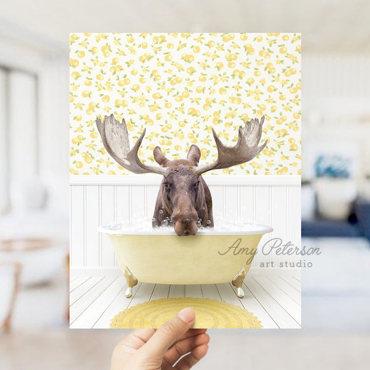 a person holding up a picture of a moose in a bathtub