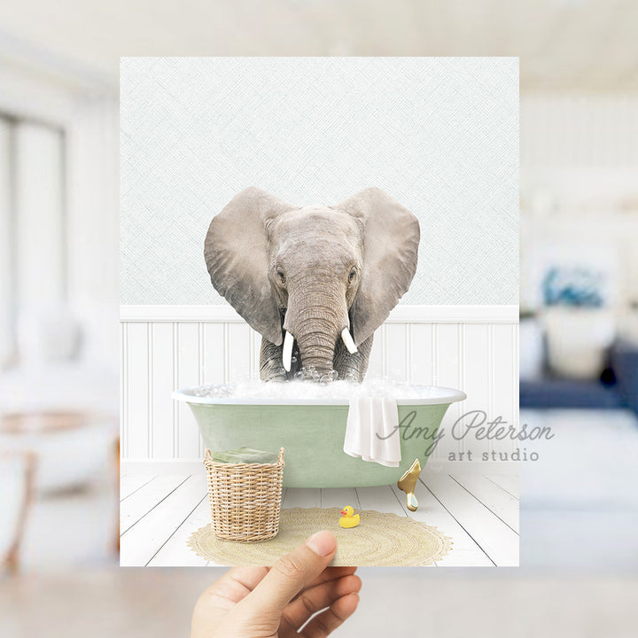 a person holding up a picture of an elephant in a bathtub