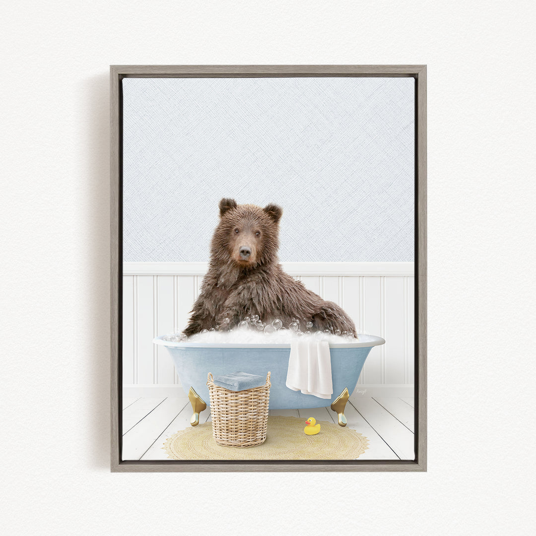A brown bear sitting in a blue bathtub filled with water, surrounded by a yellow rubber duck and a wicker basket.