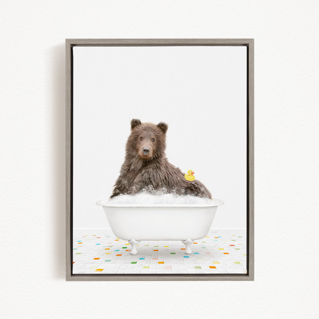 A brown bear sitting in a white bathtub filled with bubbles, with a rubber duck floating on the water.