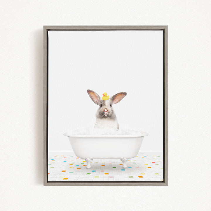 A white rabbit sitting in a white bathtub filled with bubbles, with a yellow rubber duck perched on its head.