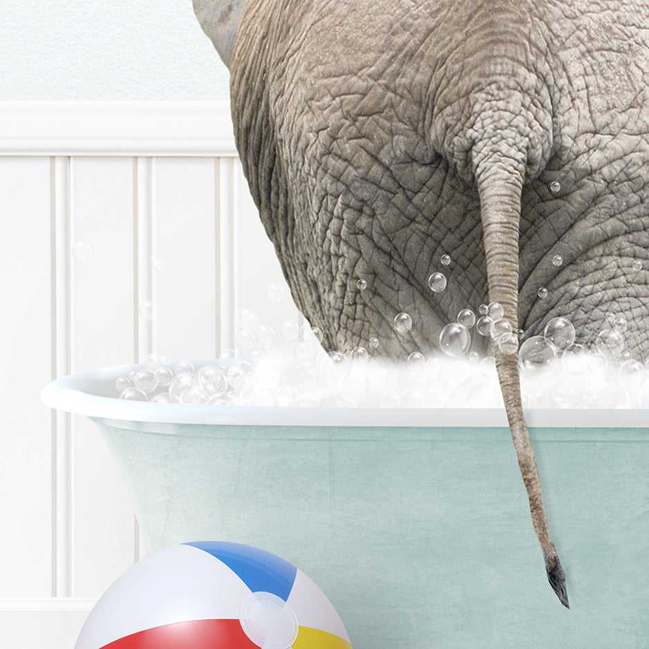 an elephant taking a bath with a beach ball