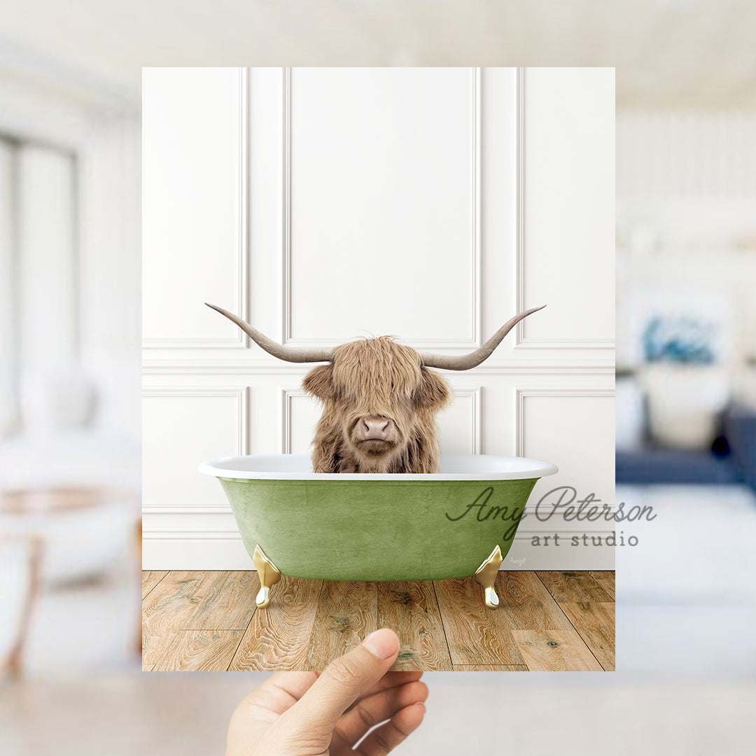 a hand holding up a card with a picture of a cow in a bathtub