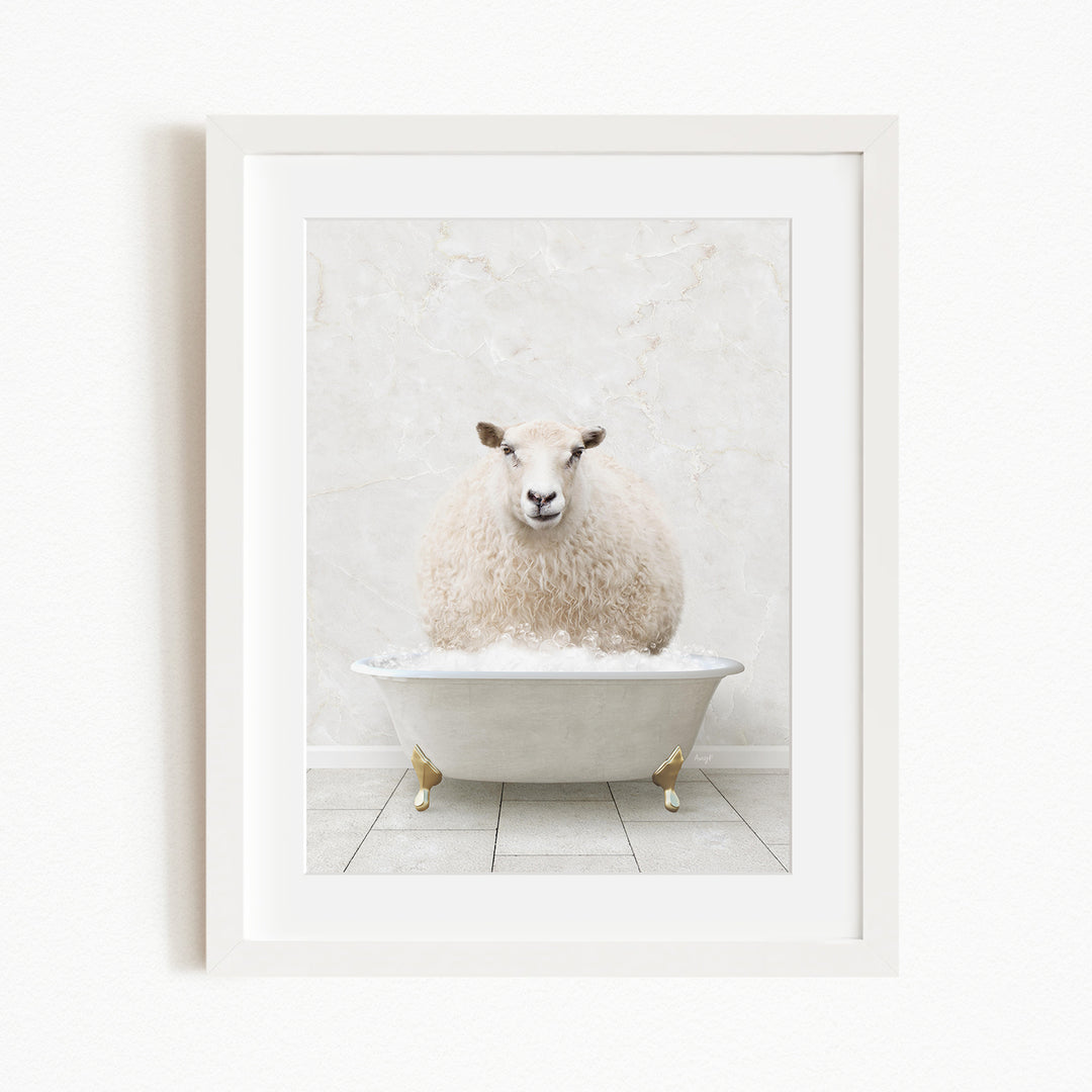 A fluffy white sheep sits in a white bathtub, surrounded by a white marble wall.