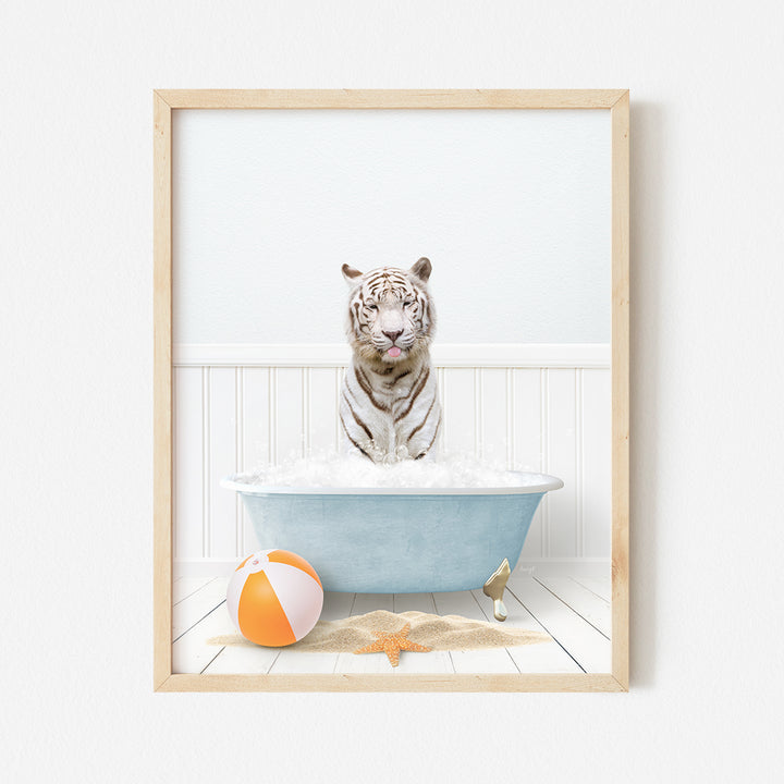 a white tiger sitting in a bathtub with a beach ball