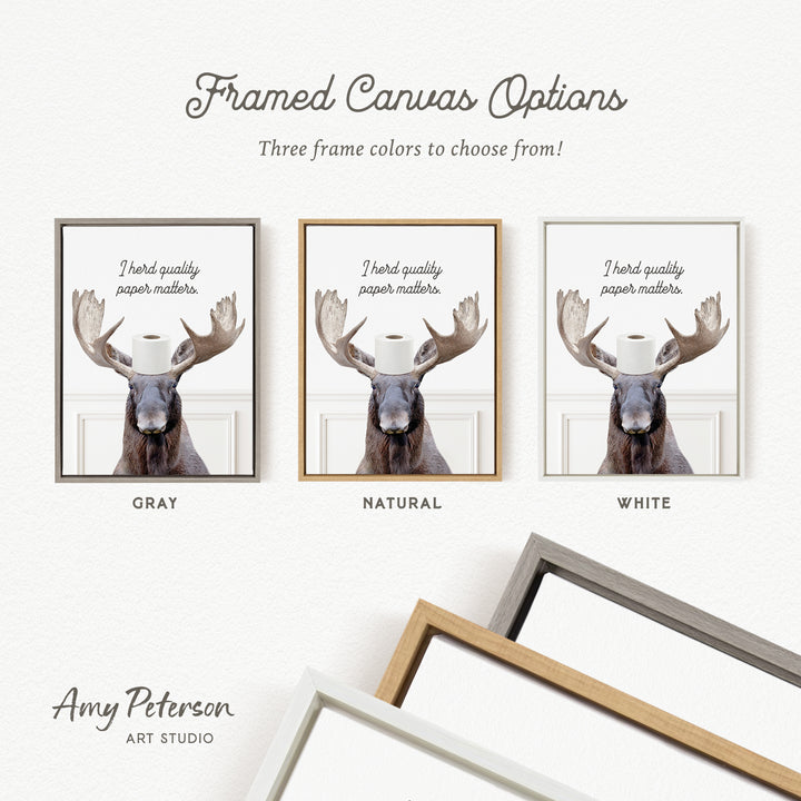 three framed canvas options, each featuring a moose with a toilet paper roll on its head. The options include a gray frame, a natural frame, and a white frame.