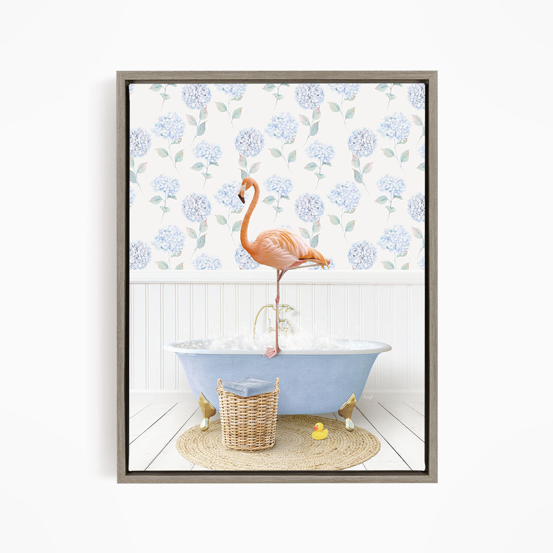 A pink flamingo stands on the edge of a blue bathtub filled with water, surrounded by a wicker basket and yellow rubber ducks.