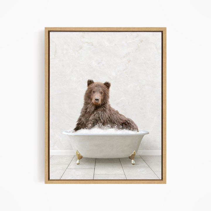 A brown bear sitting in a white bathtub filled with water, looking directly at the camera.