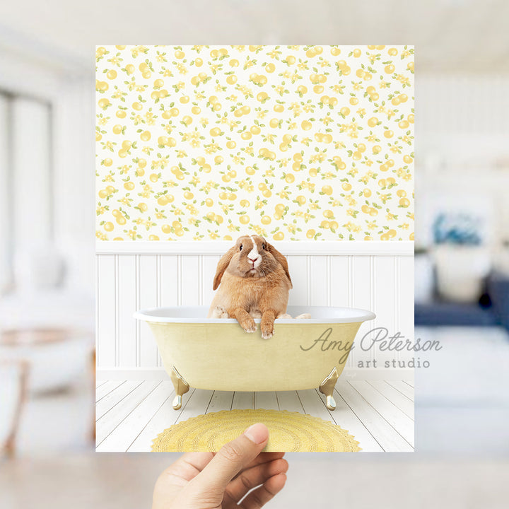 a person holding up a picture of a rabbit in a bathtub