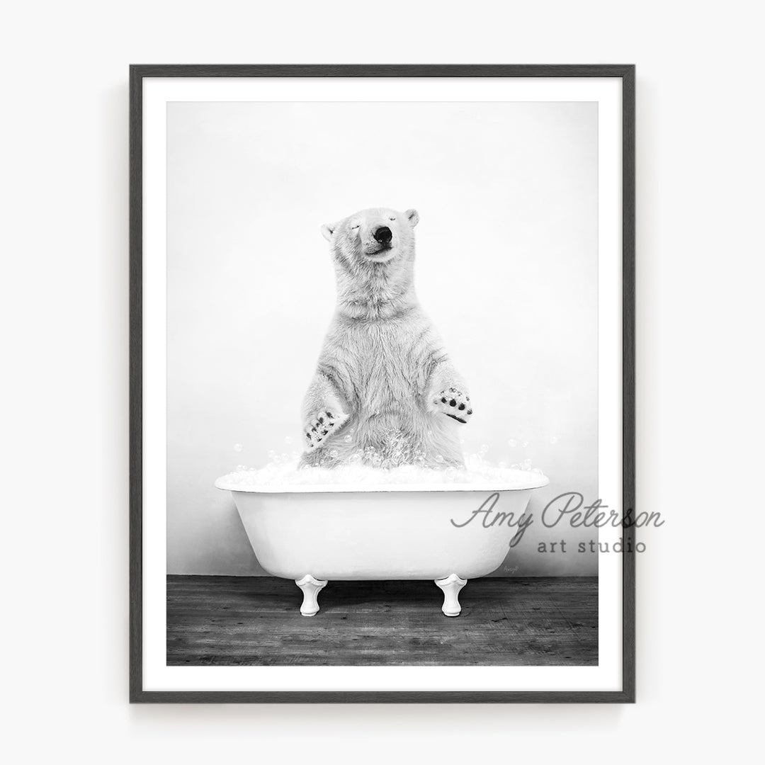 a black and white photo of a polar bear in a bathtub