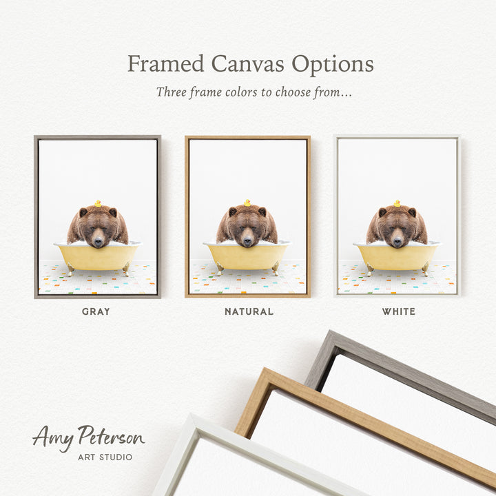 three framed canvas options, each featuring a brown bear sitting in a bathtub. The options include a gray frame, a natural frame, and a white frame.