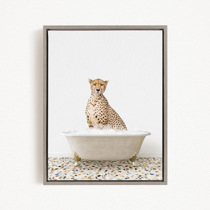 A cheetah sitting in a white bathtub filled with water, looking directly at the camera.