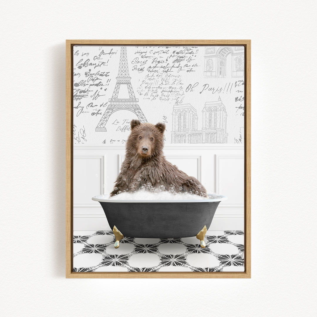 A brown bear sitting in a bathtub filled with bubbles, surrounded by a Paris-themed background with the Eiffel Tower and other Parisian architecture.