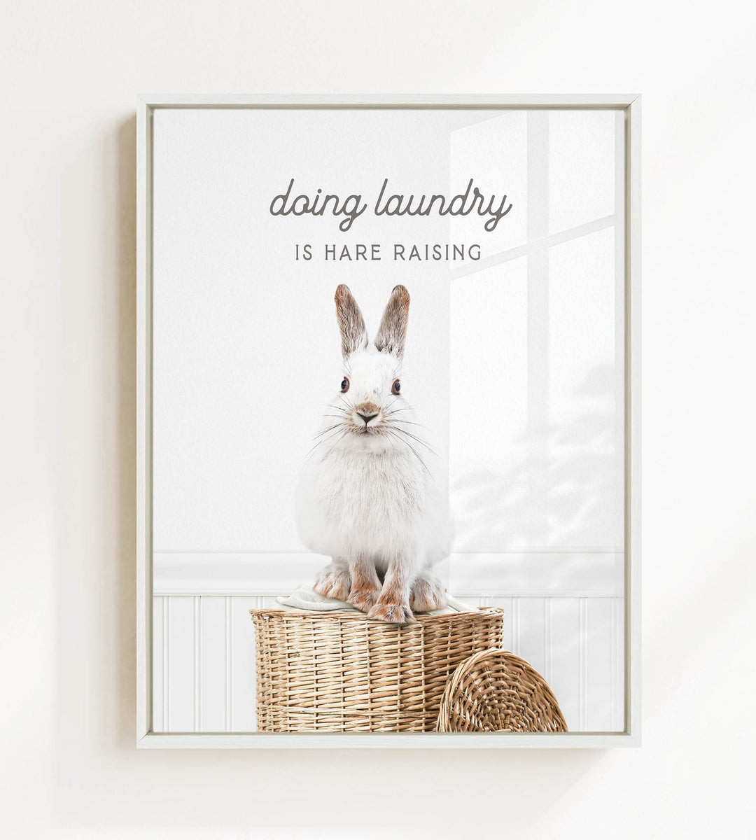 A white rabbit sitting on a woven basket, with the text "Doing laundry is Hare raising" displayed above the image.