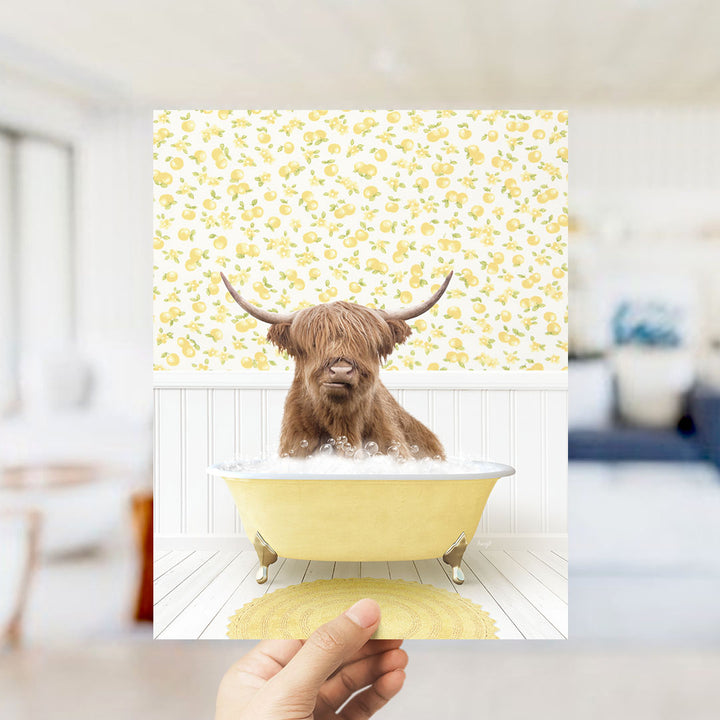 A brown cow with horns is sitting in a yellow bathtub filled with bubbles, surrounded by a yellow and white floral pattern on the wall.