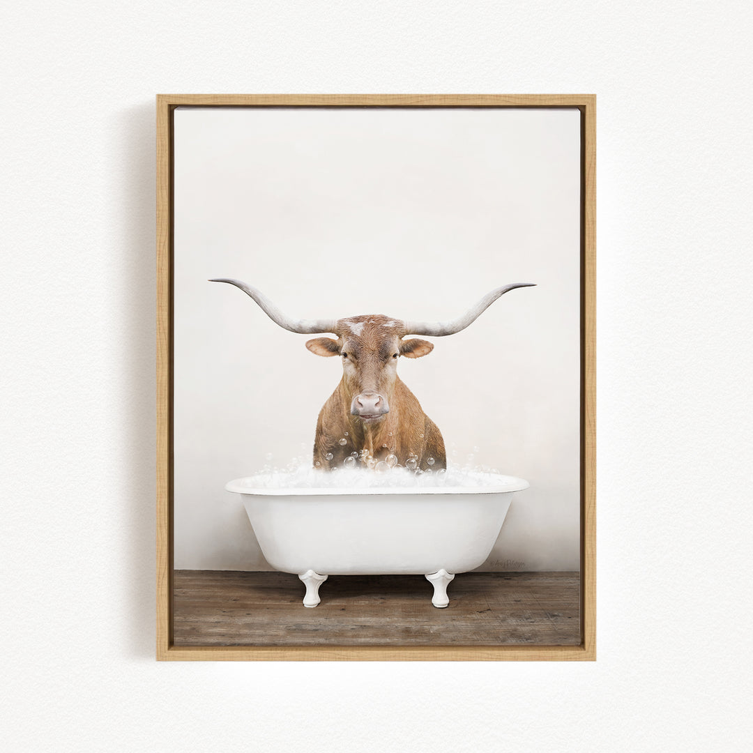 A brown cow with large horns is sitting in a white bathtub filled with water, creating a whimsical and humorous scene.