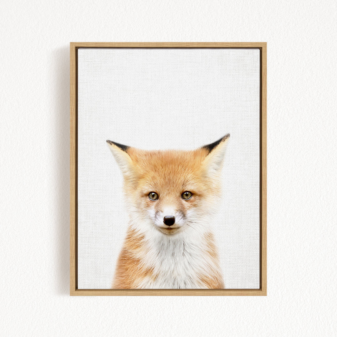 A framed print of a young fox with a friendly expression, looking directly at the camera.
