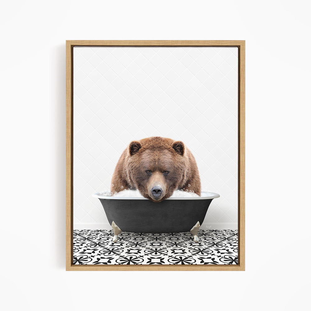 A brown bear is sitting in a black bathtub filled with water, appearing to enjoy a relaxing bath.