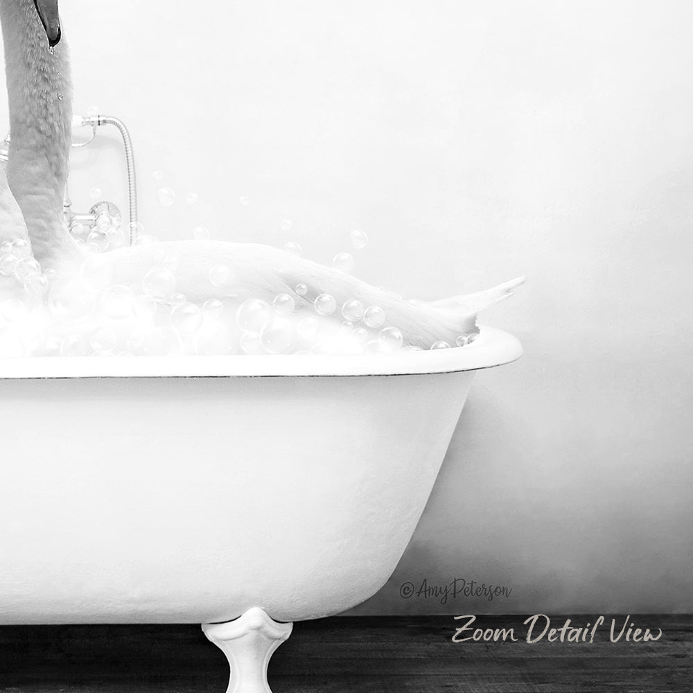 A person is taking a bath in a white bathtub, surrounded by bubbles, in a black and white image.