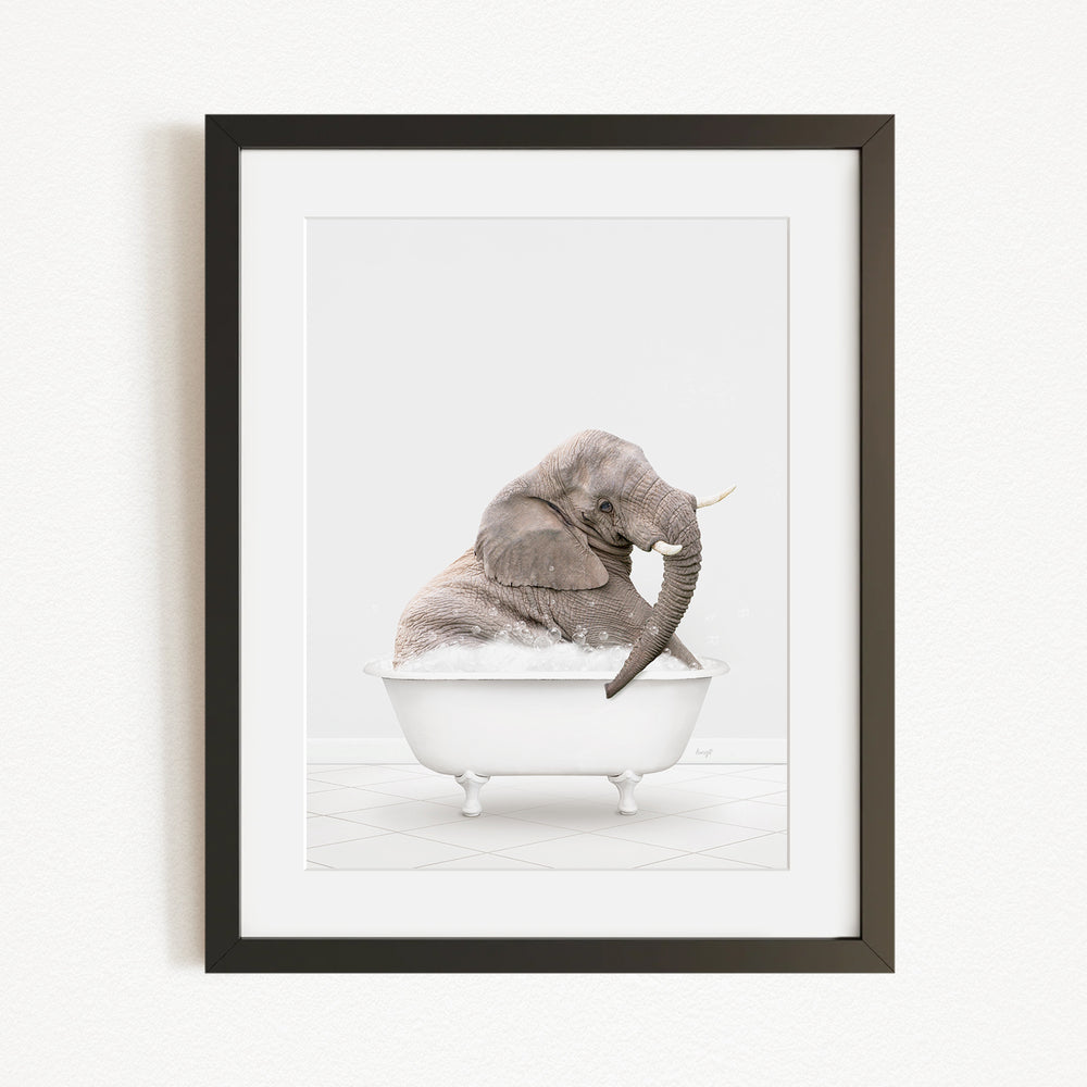 A gray elephant sitting in a white bathtub filled with water, with its trunk raised.