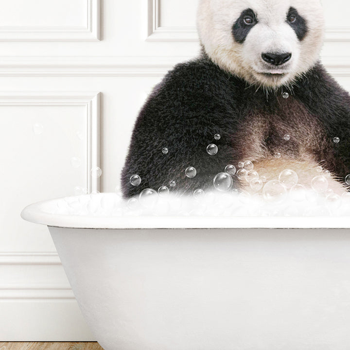 a panda bear sitting in a bathtub full of bubbles