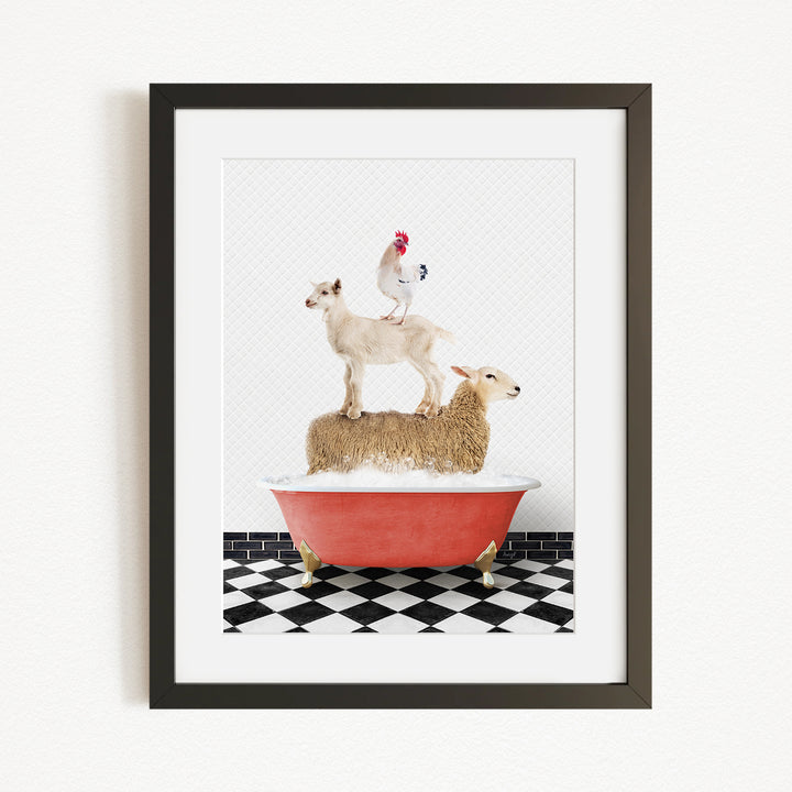 A framed image depicting a goat standing on top of a sheep in a bathtub, with a rooster perched on the sheep's back.