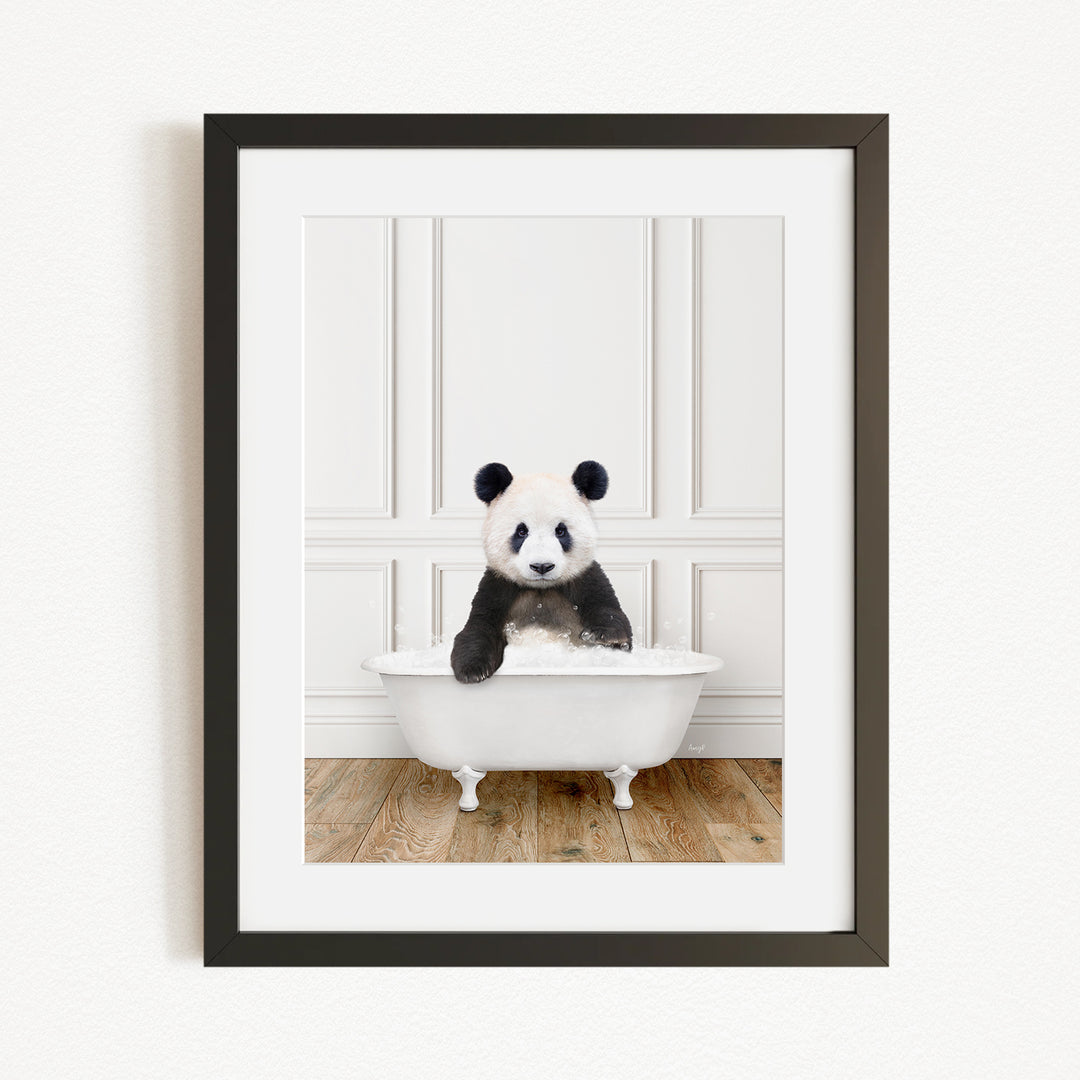 A panda bear sitting in a white bathtub, surrounded by a wooden floor and white walls.