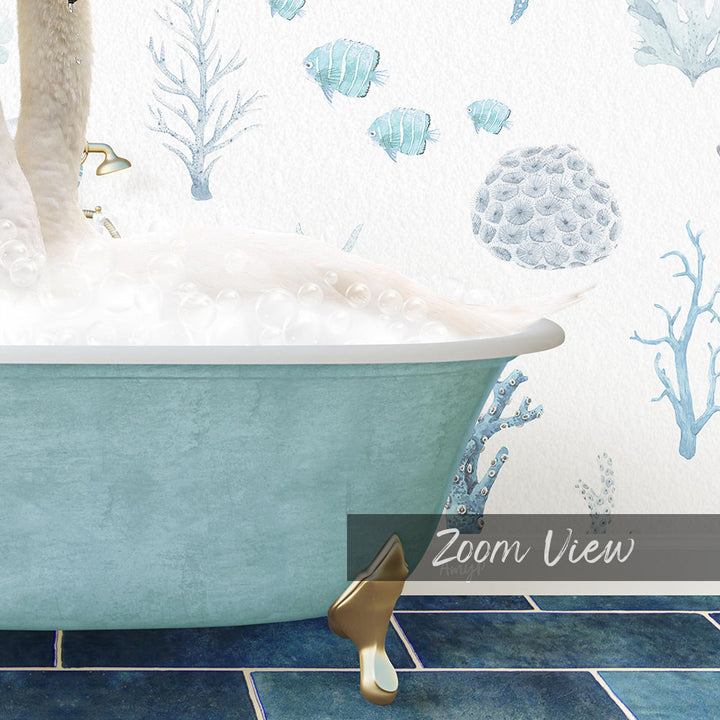A blue bathtub filled with bubbles, surrounded by a wallpaper with illustrations of fish and coral.