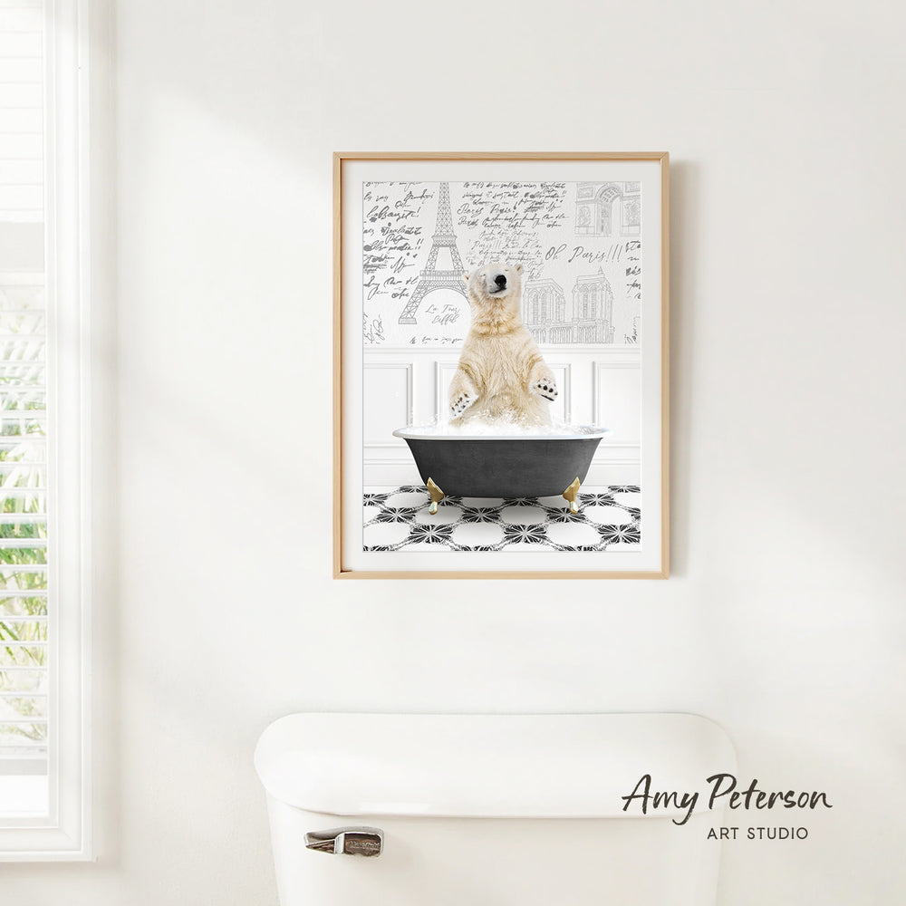 A framed image of a polar bear sitting in a bathtub, with a drawing of the Eiffel Tower in the background.
